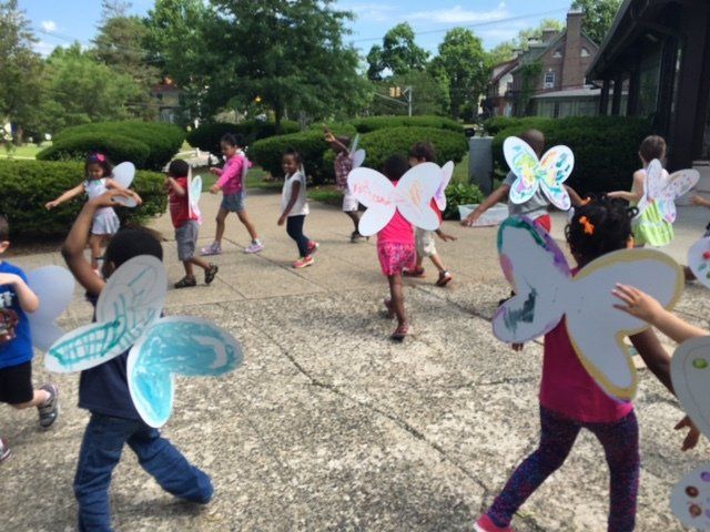 A group of children wearing paper butterflies on their wings