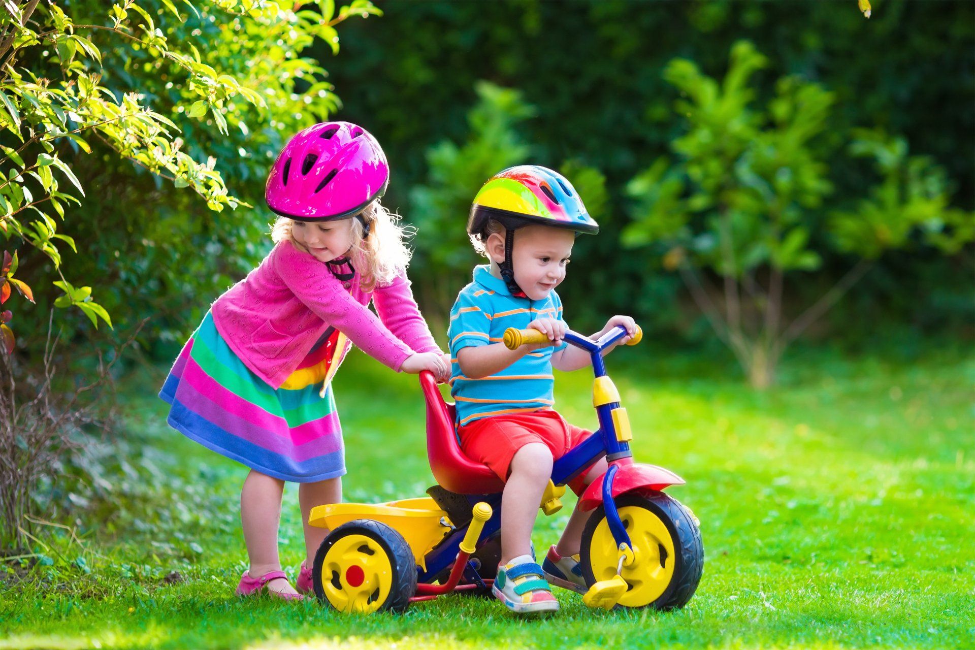 Children enjoy bike ride in the garden