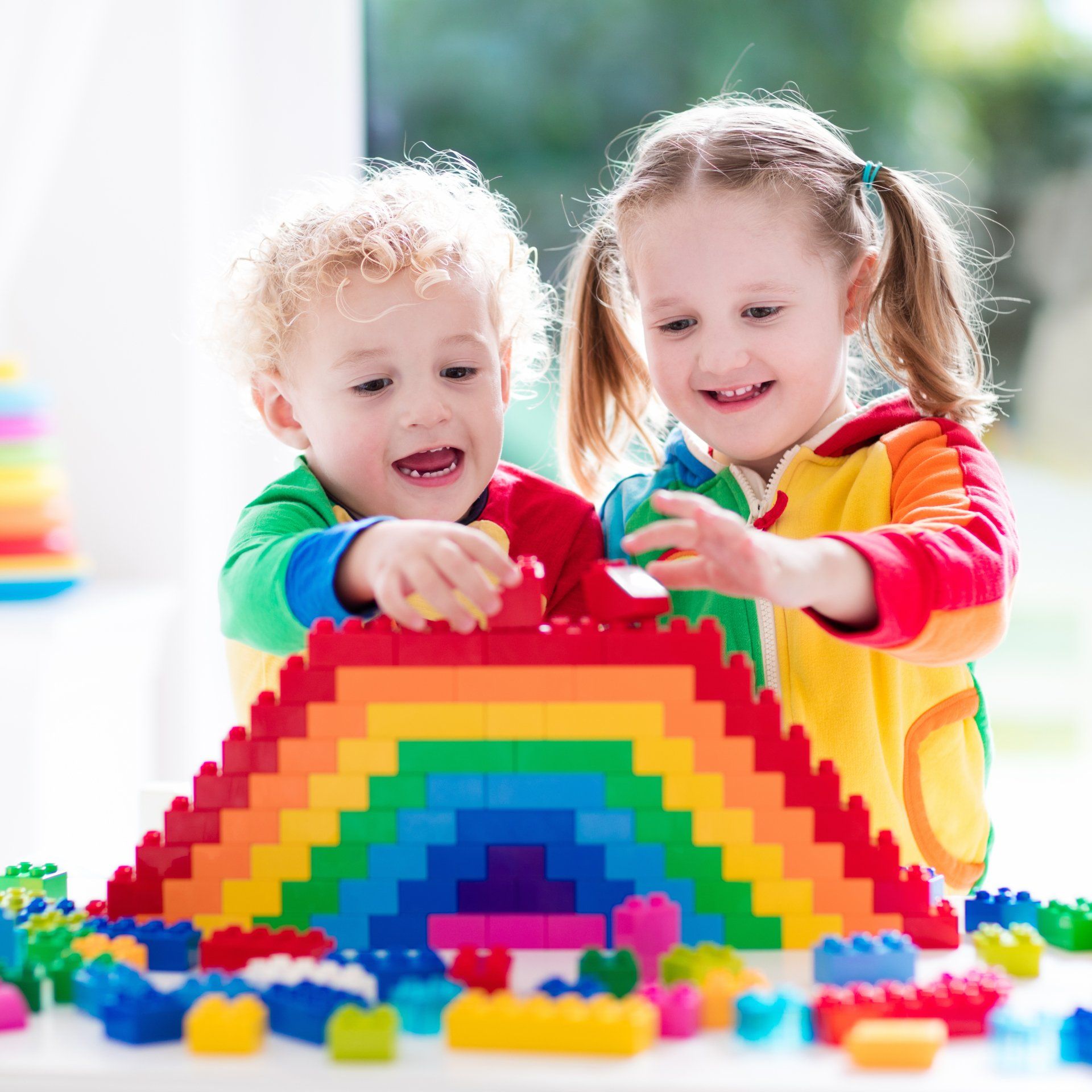 Child playing with colorful toys.