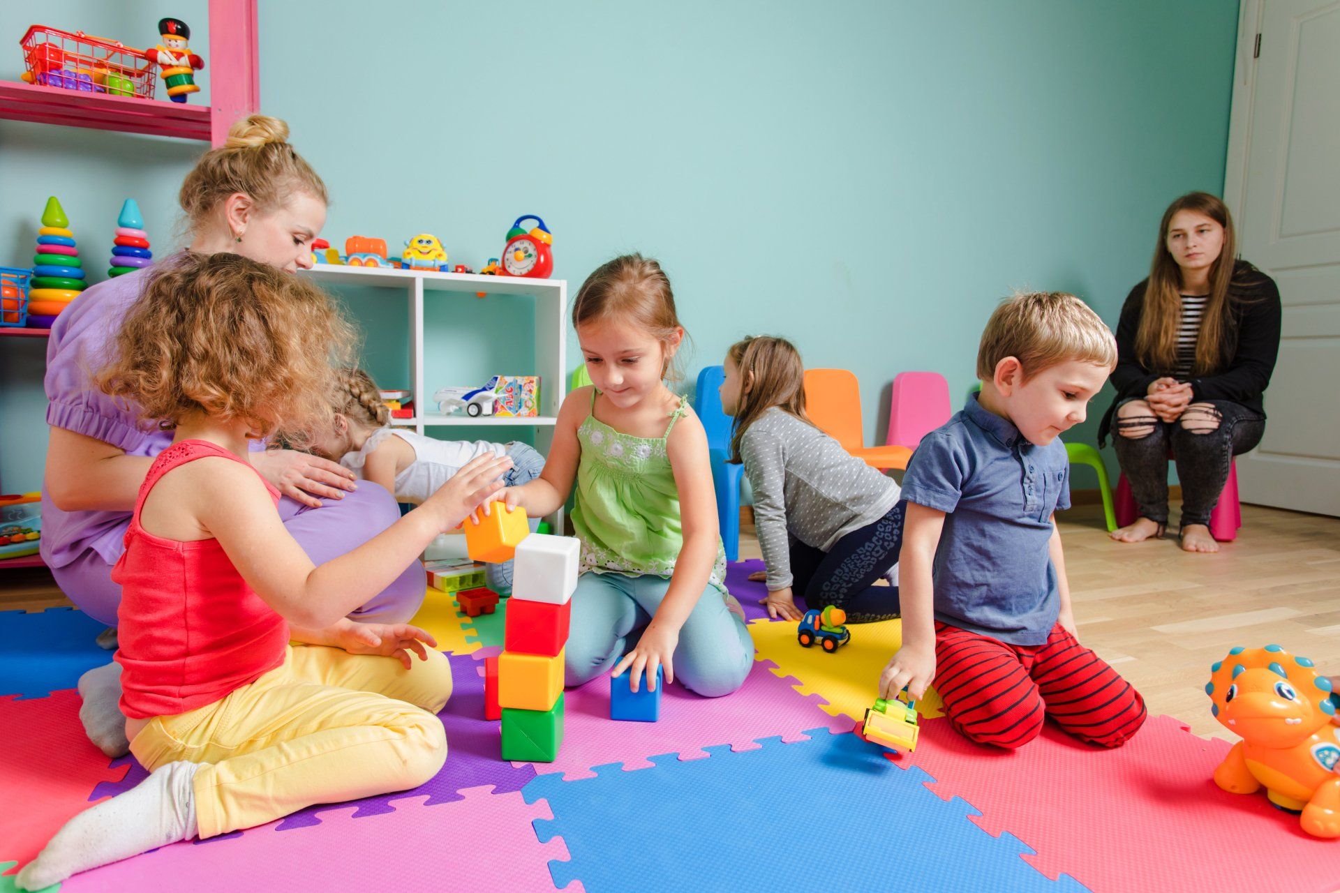 Kids playing together on a colorful mats
