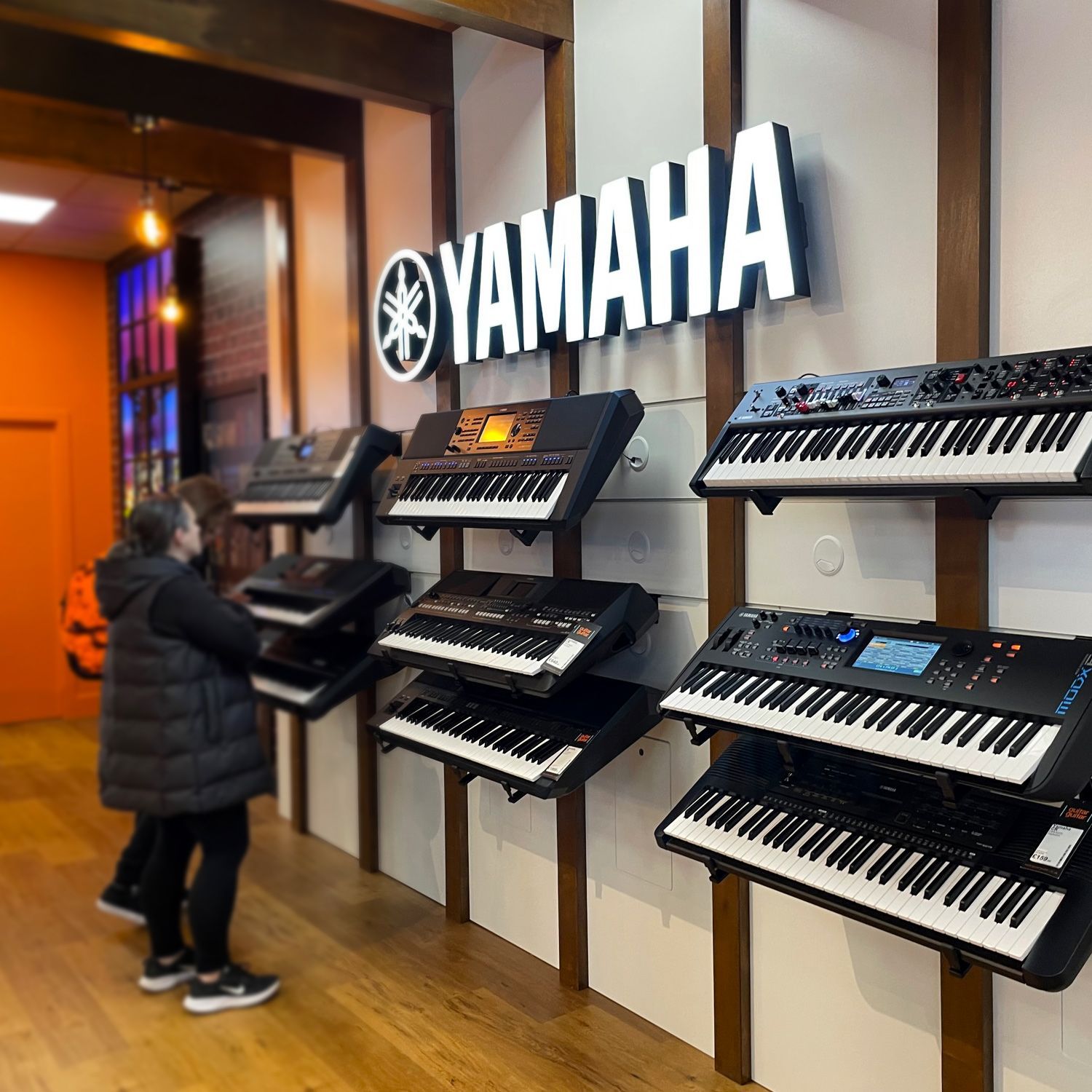 Yamaha branded retail space with custom illuminated logo and lightbox graphics 