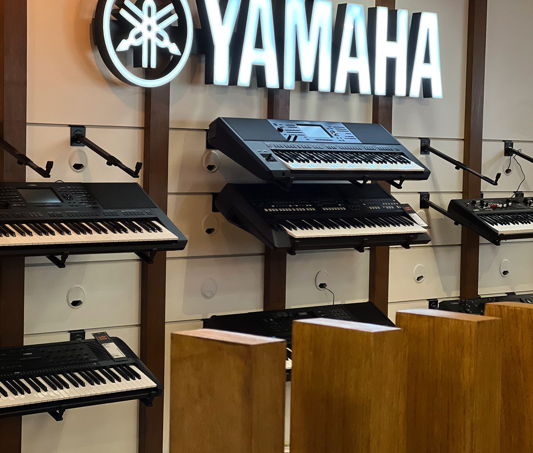 Yamaha branded retail space with product shelving, custom illuminated logo and lightbox graphics 
