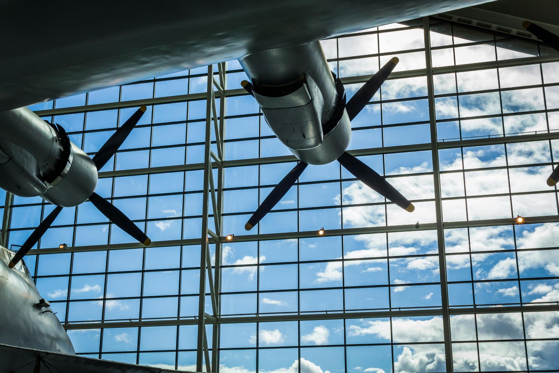 A plane is hanging from the ceiling of a building.