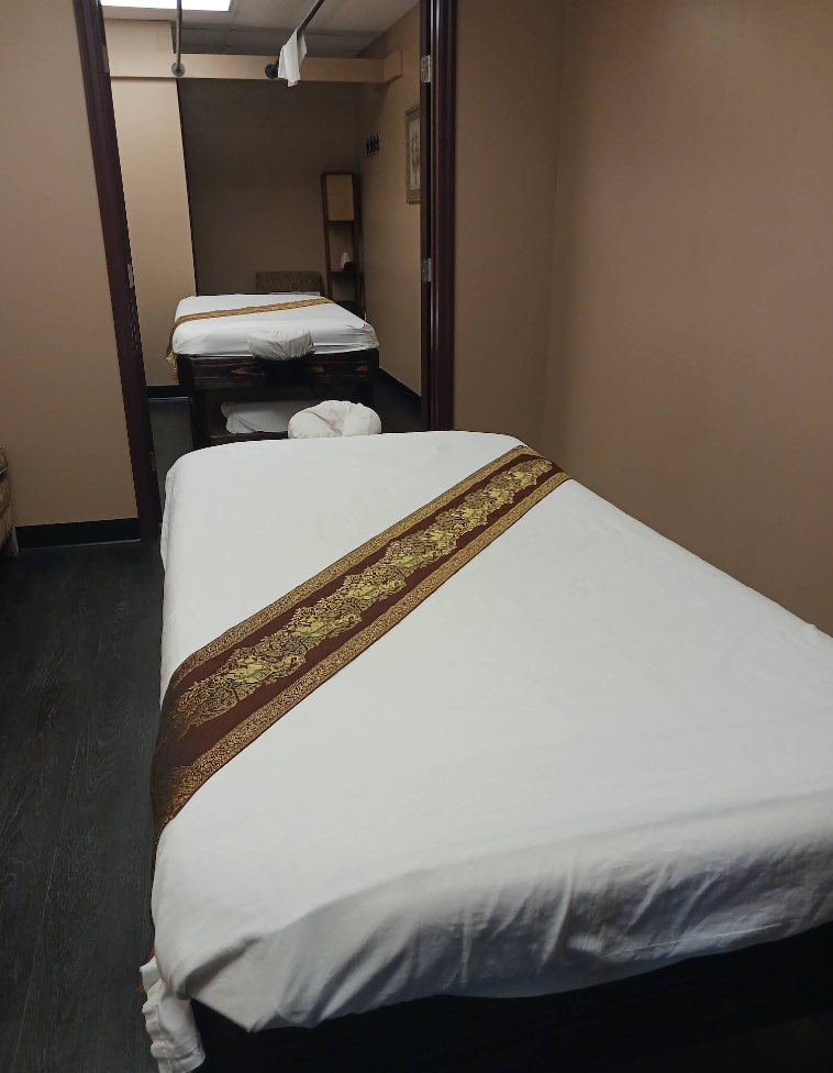 A bed with a brown and gold stripe on it