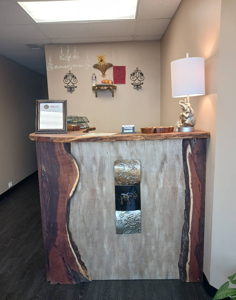 A wooden counter with a lamp and a certificate on it