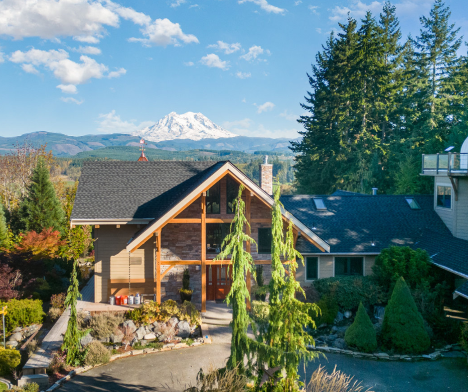An aerial view of a house with a mountain in the background