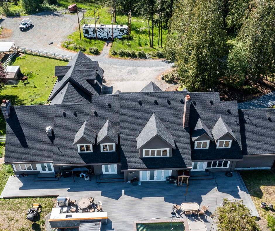 An aerial view of a large house with a pool in the backyard