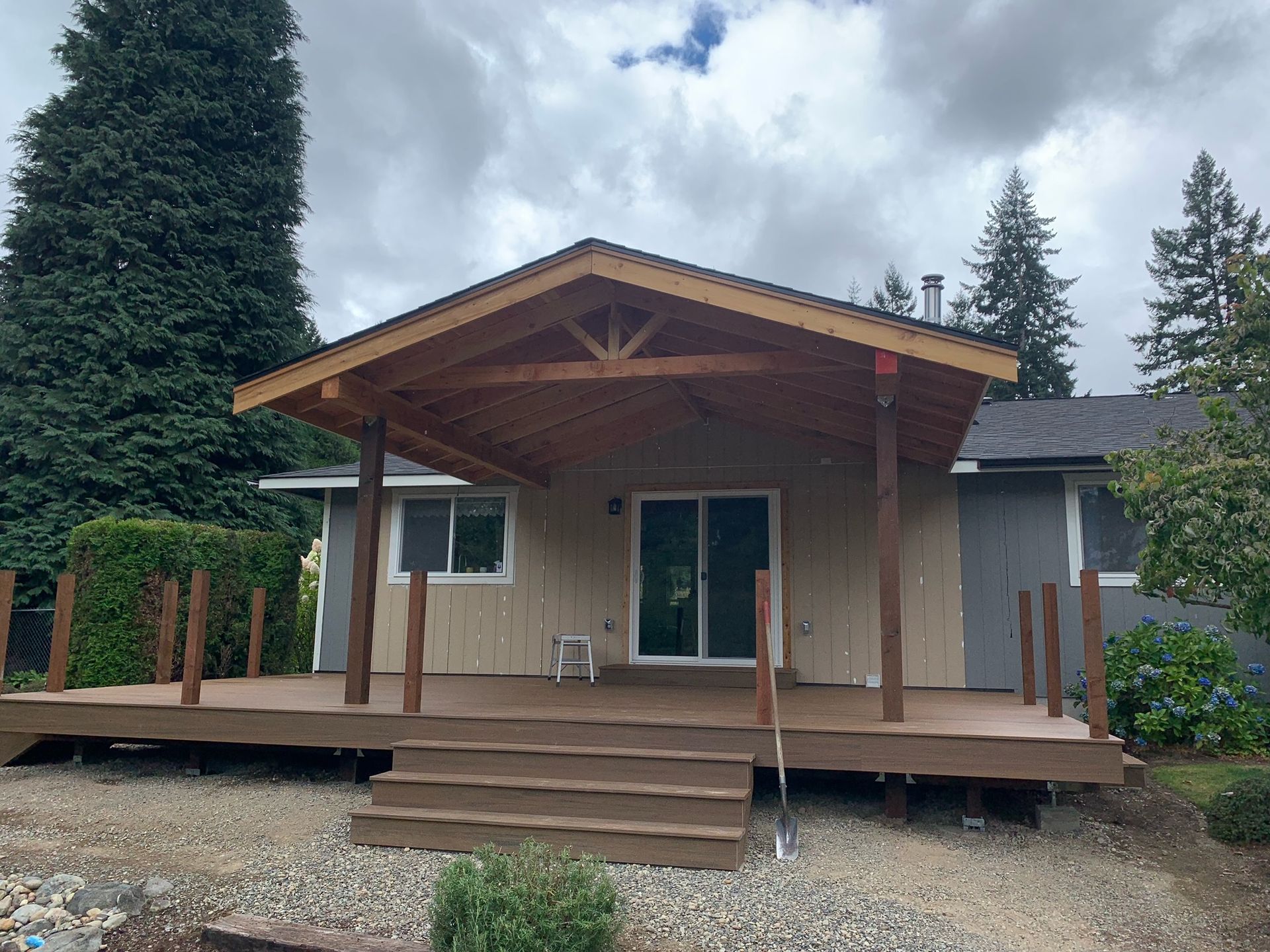 A house with a wooden deck and a covered porch.