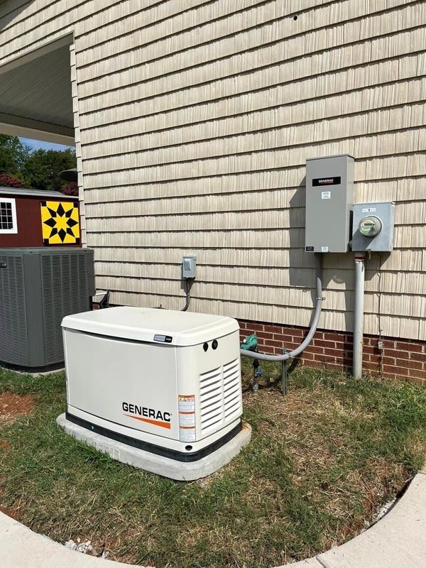 A Generac generator next to a house with an electrical box.