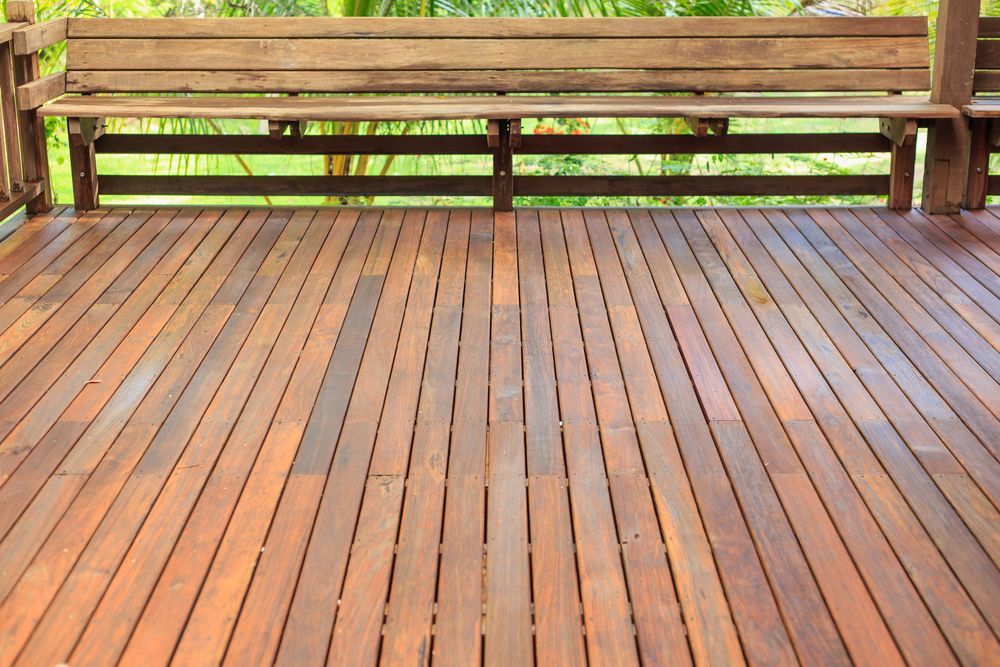 A Wooden Deck With A Bench In The Background — Sedah Home Improvements In Port Macquarie, NSW