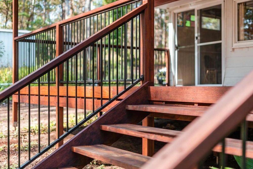 A Wooden Deck With Stairs Leading Up To It And A Metal Railing — Sedah Home Improvements In Port Macquarie, NSW
