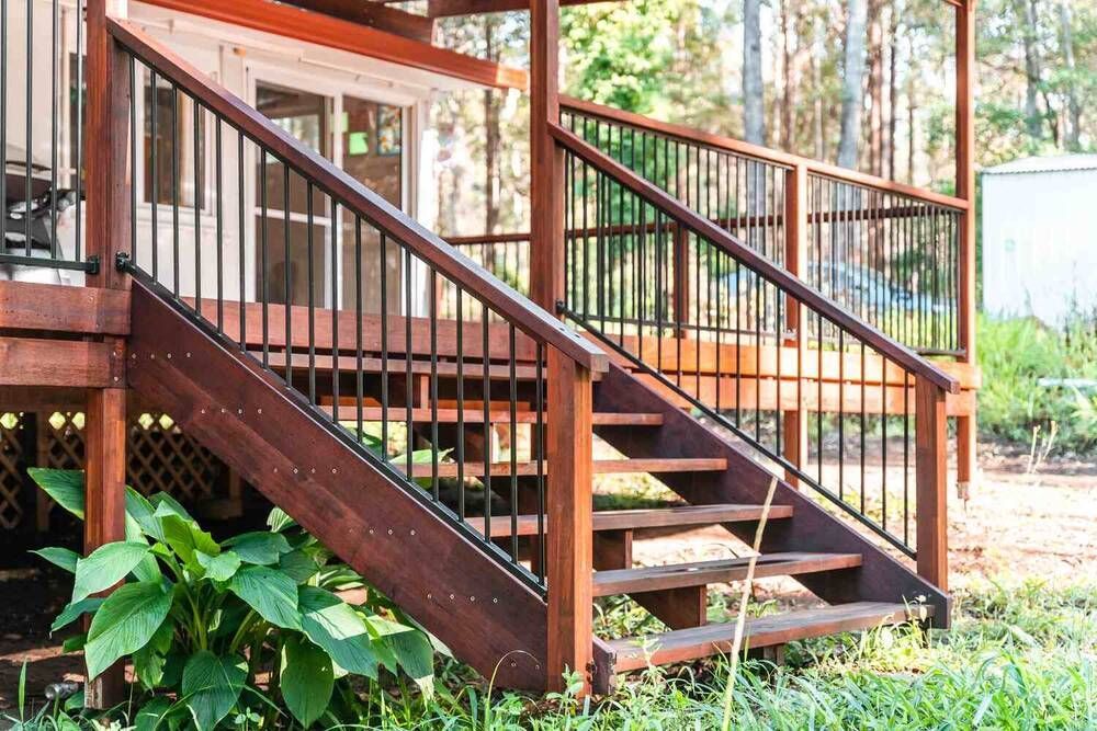 A Wooden Deck With Stairs Leading Up To It And A Metal Railing — Sedah Home Improvements In Port Macquarie, NSW