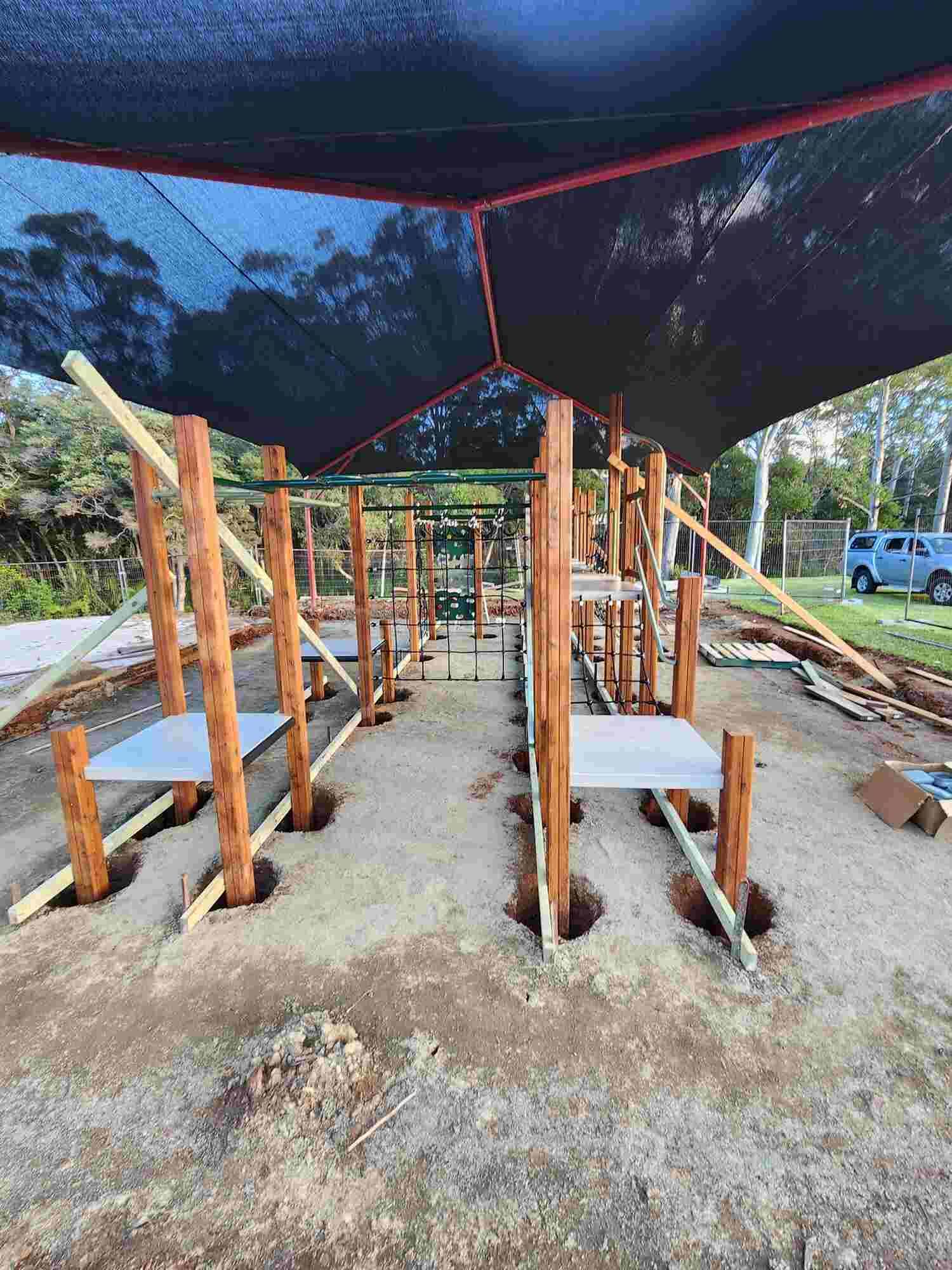 A Wooden Structure Is Being Built In The Dirt Under A Canopy — Sedah Home Improvements In Port Macquarie, NSW
