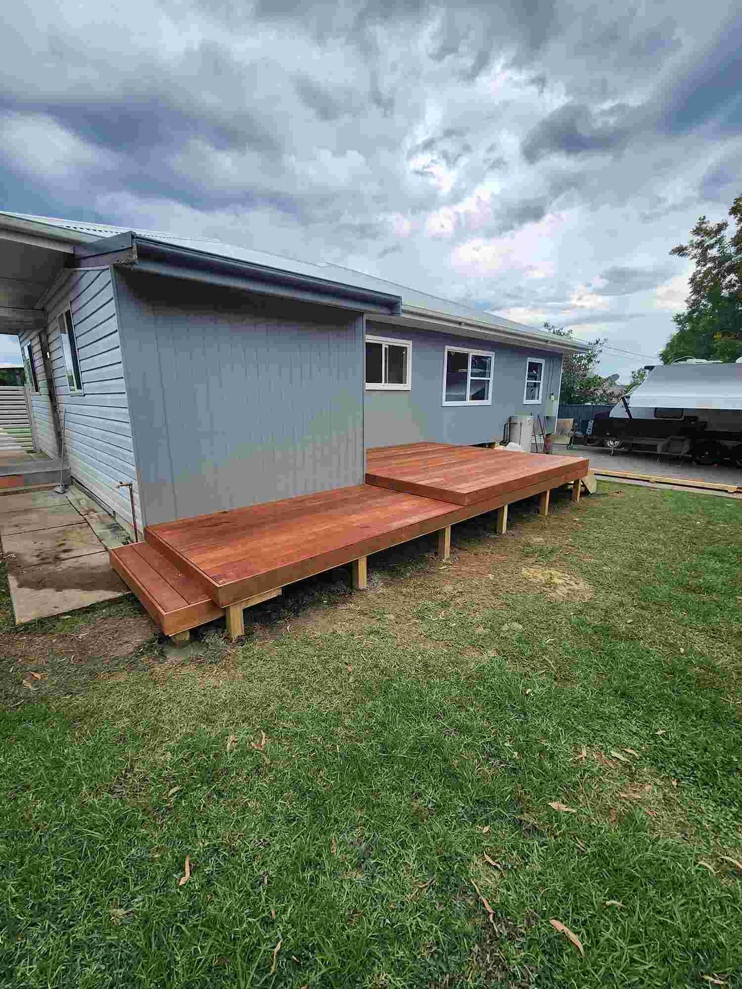 A Wooden Deck Is Being Built In Front Of A House — Sedah Home Improvements In Port Macquarie, NSW