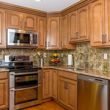 Kitchen with Mocha Wood Cabinetry — Bourbonnais, IL — Heartland Cabinetry & More