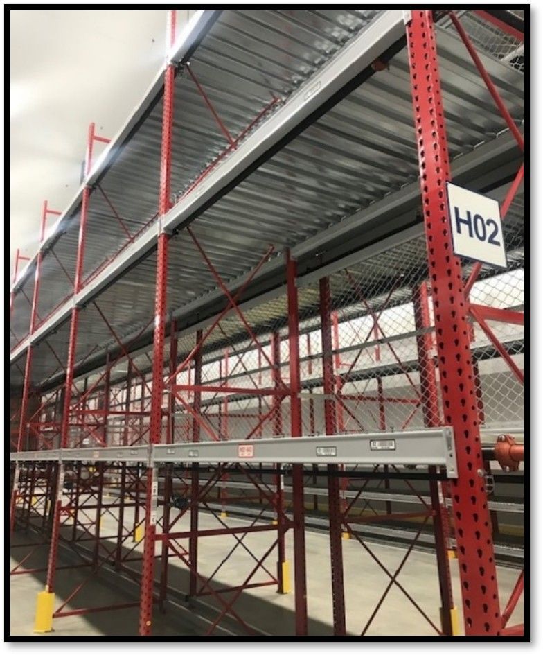 Red and gray industrial shelving system inside a warehouse;