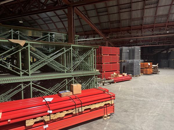 Two workers in safety vests and hard hats examining cargo containers. One points upward. Two workers in safety vests and hard hats examining cargo containers. One points upward.