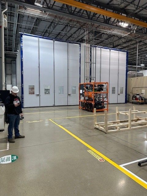 Warehouse interior with tall shelving packed with cardboard boxes and packaged goods.