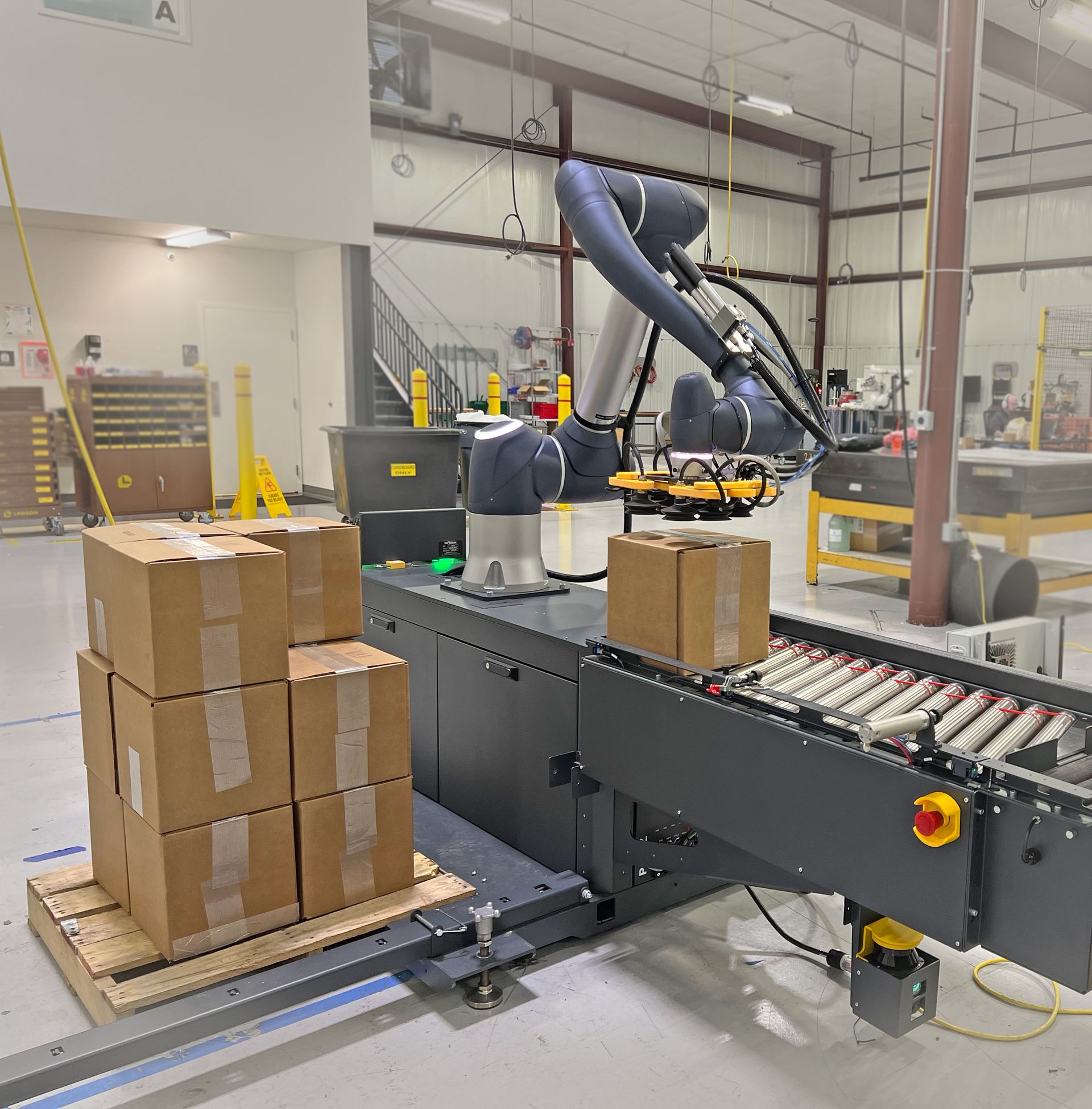 Robots in a warehouse sorting and moving cardboard boxes along conveyor belts. Robots in a warehouse sorting and moving cardboard boxes along conveyor belts.