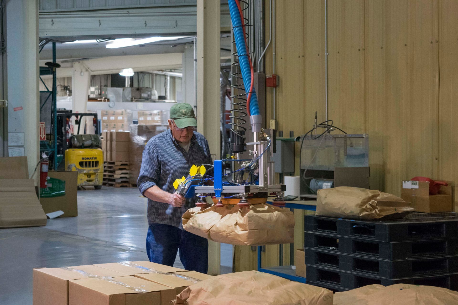 Warehouse workers operating forklift near shelves filled with boxes. Warehouse workers operating forklift near shelves filled with boxes.
