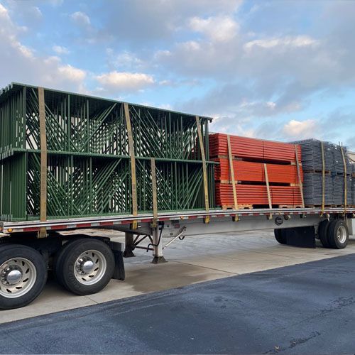 Blue and orange industrial racking system inside a warehouse.