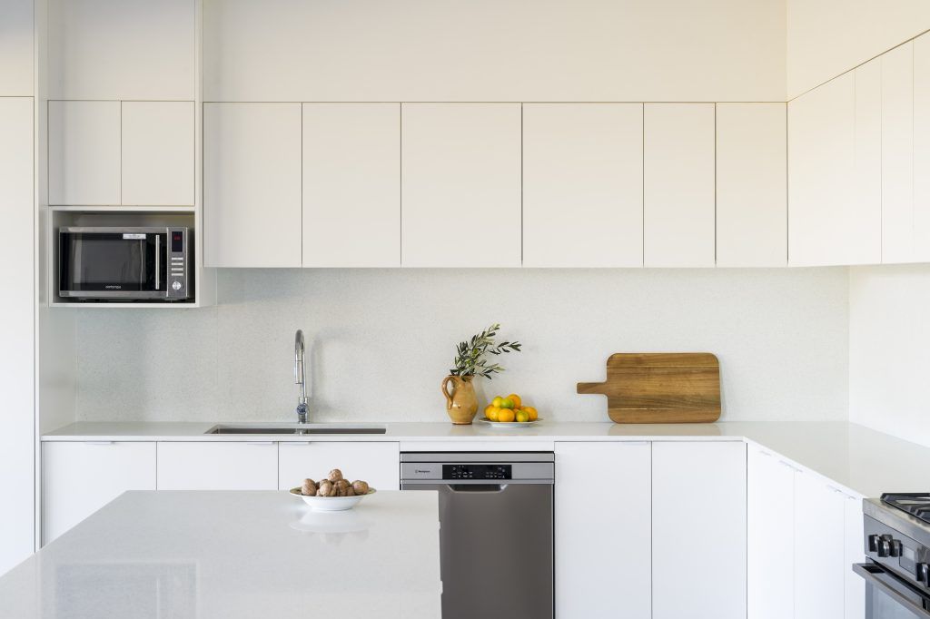 A Kitchen With White Cabinets and Stainless Steel Appliances — Stone Effects In Forest Glen, QLD