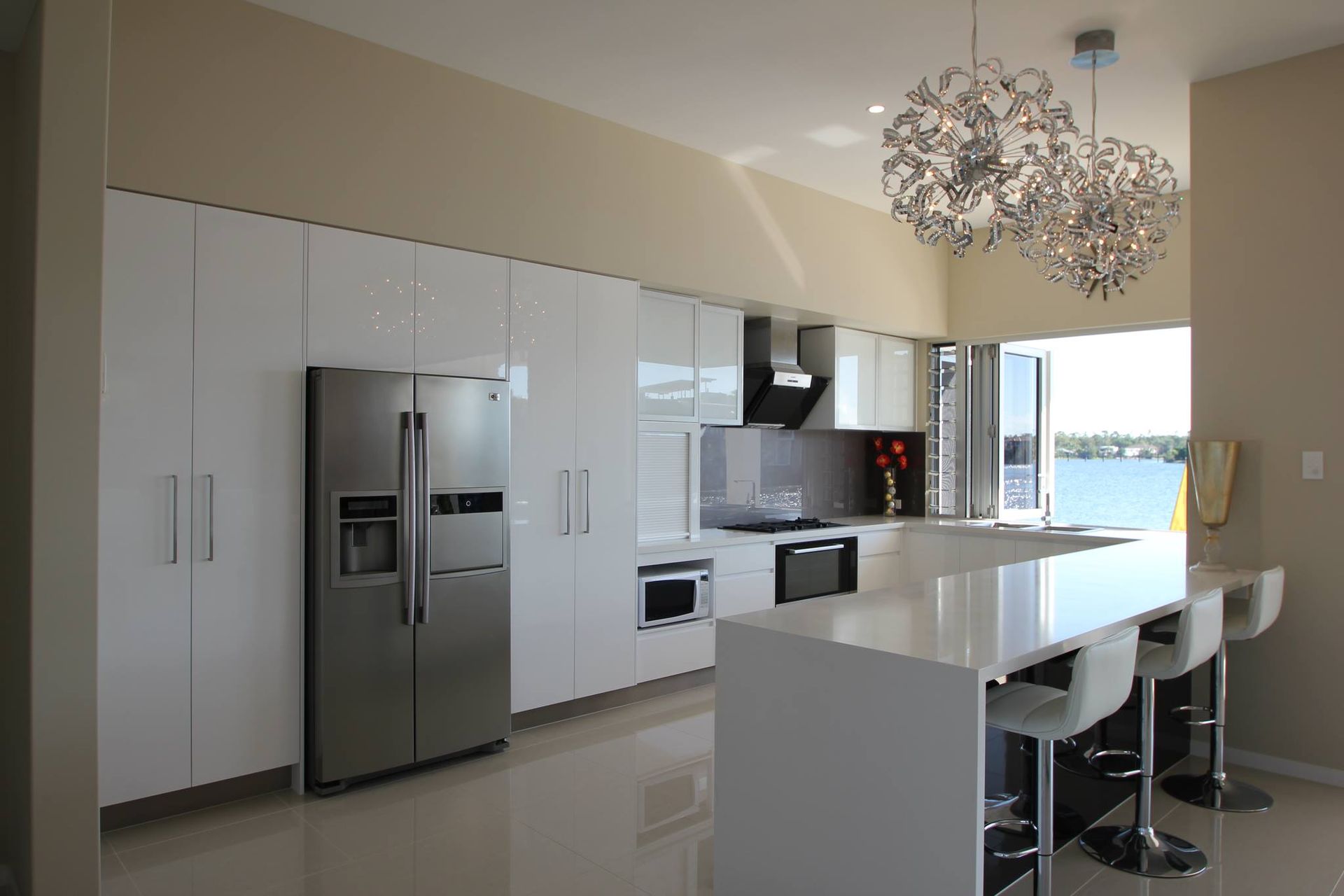A Kitchen With White Cabinets and a Stainless Steel Refrigerator — Stone Effects In Forest Glen, QLD