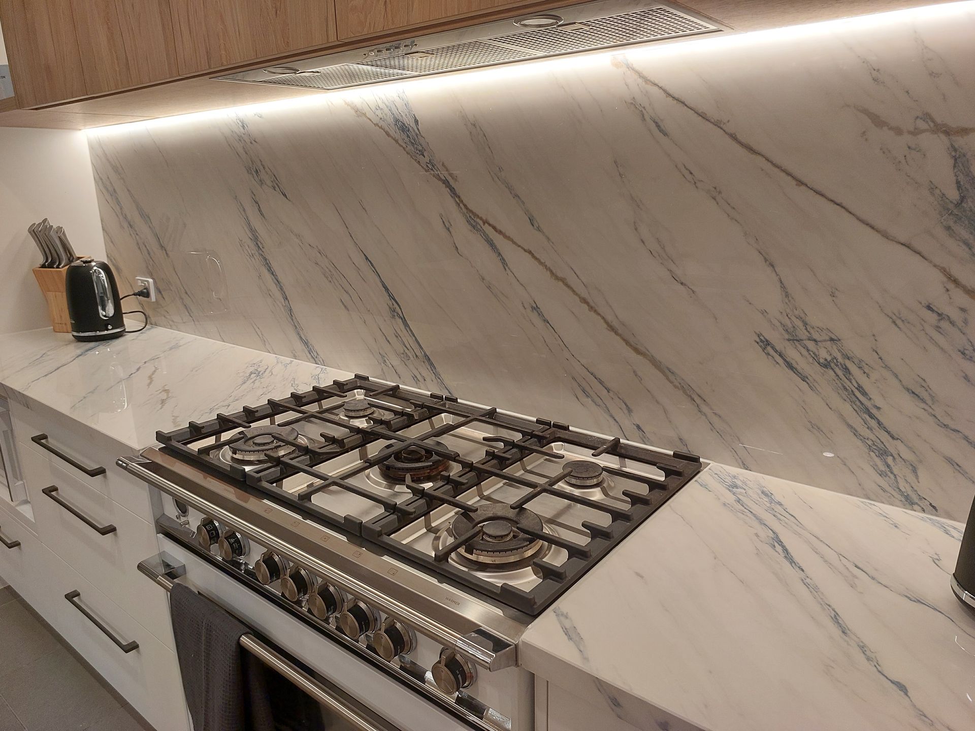 A Kitchen With a Stove Top Oven and a Marble Counter Top — Stone Effects In Forest Glen, QLD