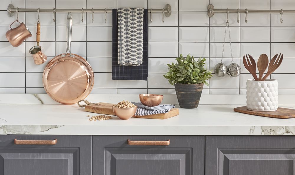 A Kitchen Counter With Pots, Pans, Utensils and a Plant — Stone Effects In Forest Glen, QLD