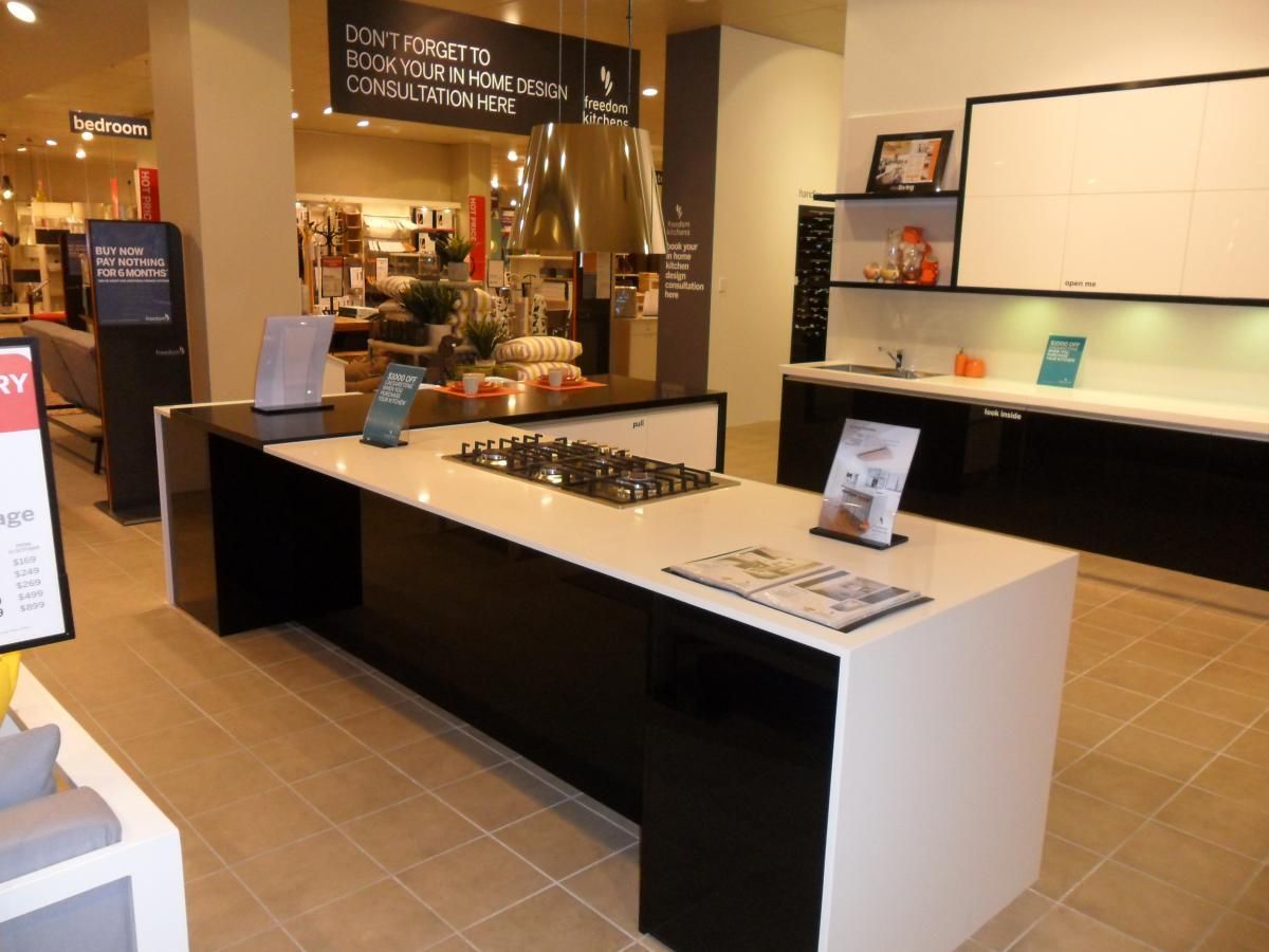 A Kitchen With a Large Island and a Stove Top Oven — Stone Effects In Forest Glen, QLD