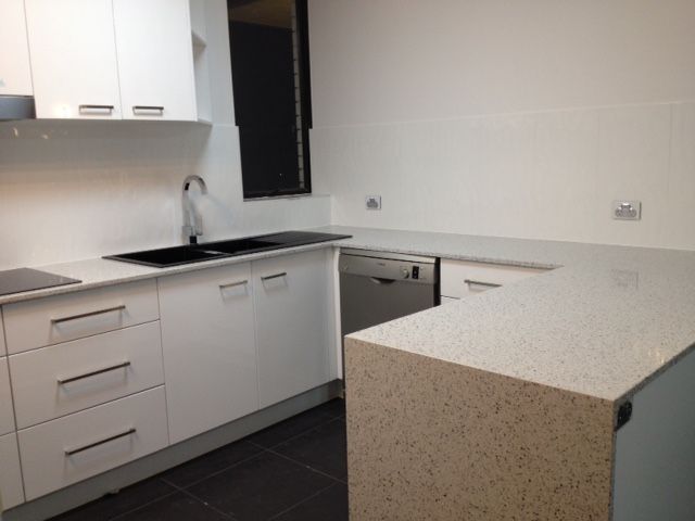A Kitchen With White Cabinets and Granite Counter Tops — Stone Effects In Forest Glen, QLD