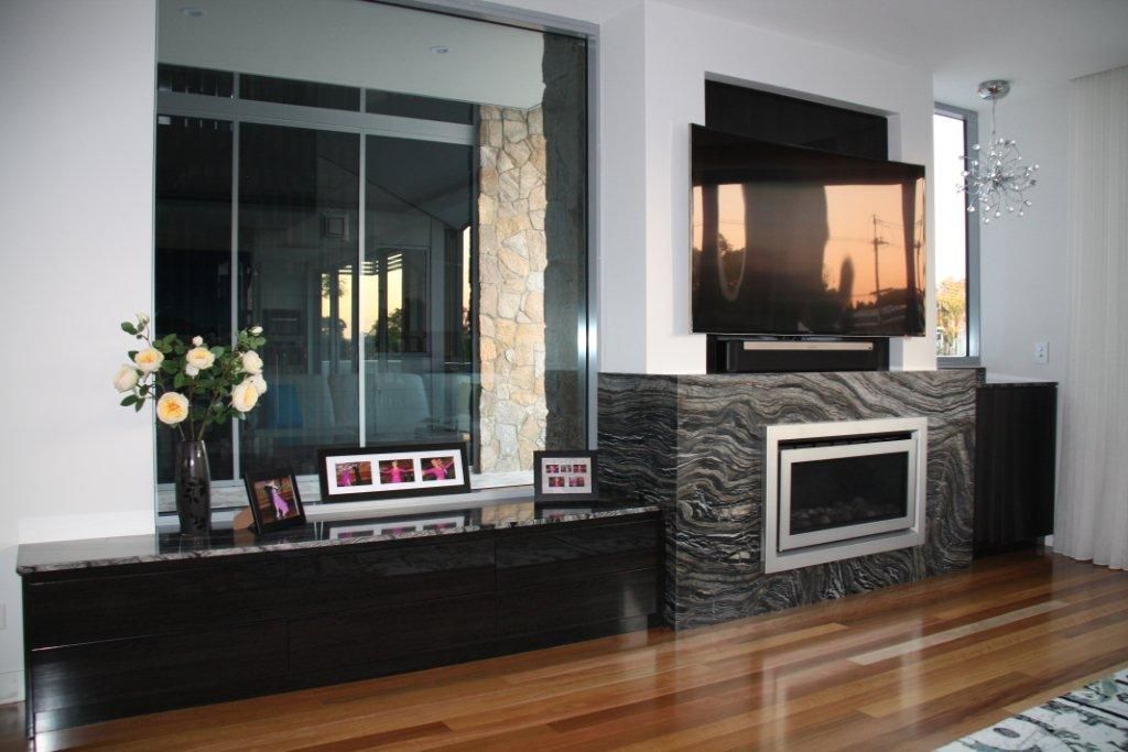 A Living Room With a Fireplace and a Flat Screen Tv — Stone Effects In Forest Glen, QLD