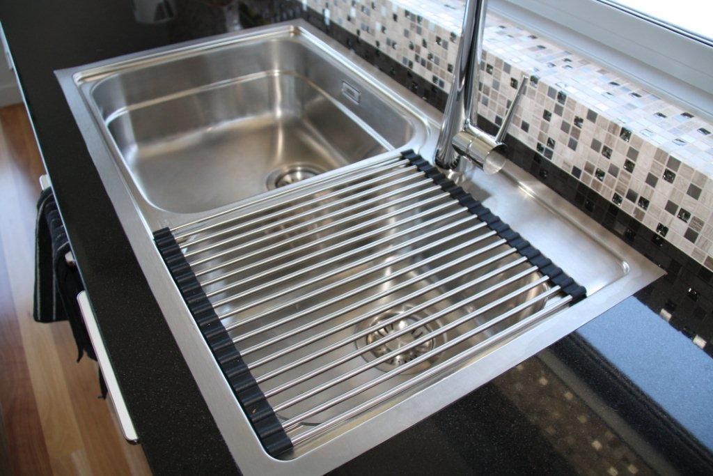 A Stainless Steel Kitchen Sink With a Black Counter Top — Stone Effects In Forest Glen, QLD