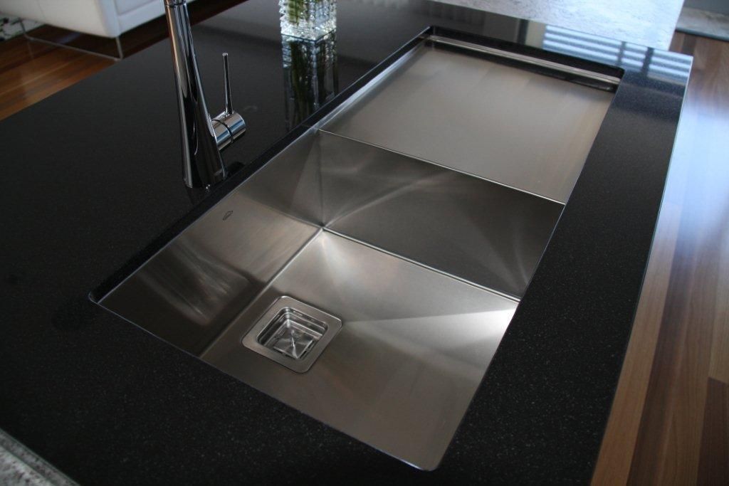 A Stainless Steel Sink Sits on a Black Counter Top — Stone Effects In Forest Glen, QLD