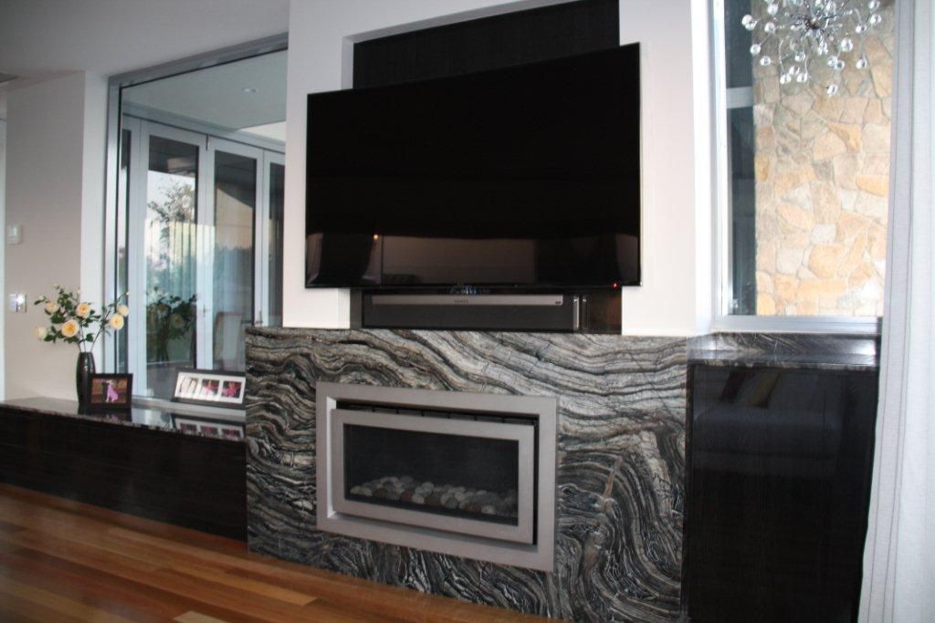A Living Room With a Fireplace and a Flat Screen Tv — Stone Effects In Forest Glen, QLD