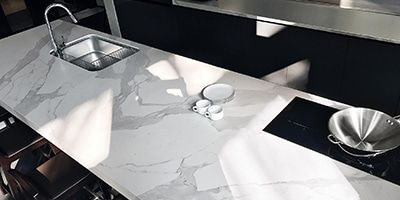 A Kitchen Counter With a Sink and a Stove Top Oven — Stone Effects In Forest Glen, QLD