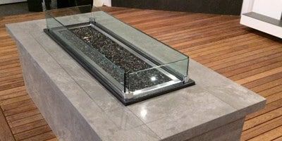 A Fire Pit is Sitting on Top of a Wooden Table — Stone Effects In Forest Glen, QLD