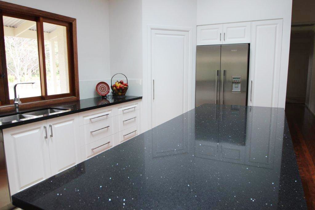 A Kitchen With Black Counter Tops and White Cabinets — Stone Effects In Forest Glen, QLD