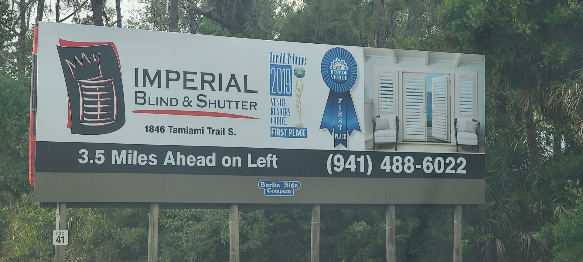 A billboard for imperial blinds and shutters is 3.5 miles ahead on loft
