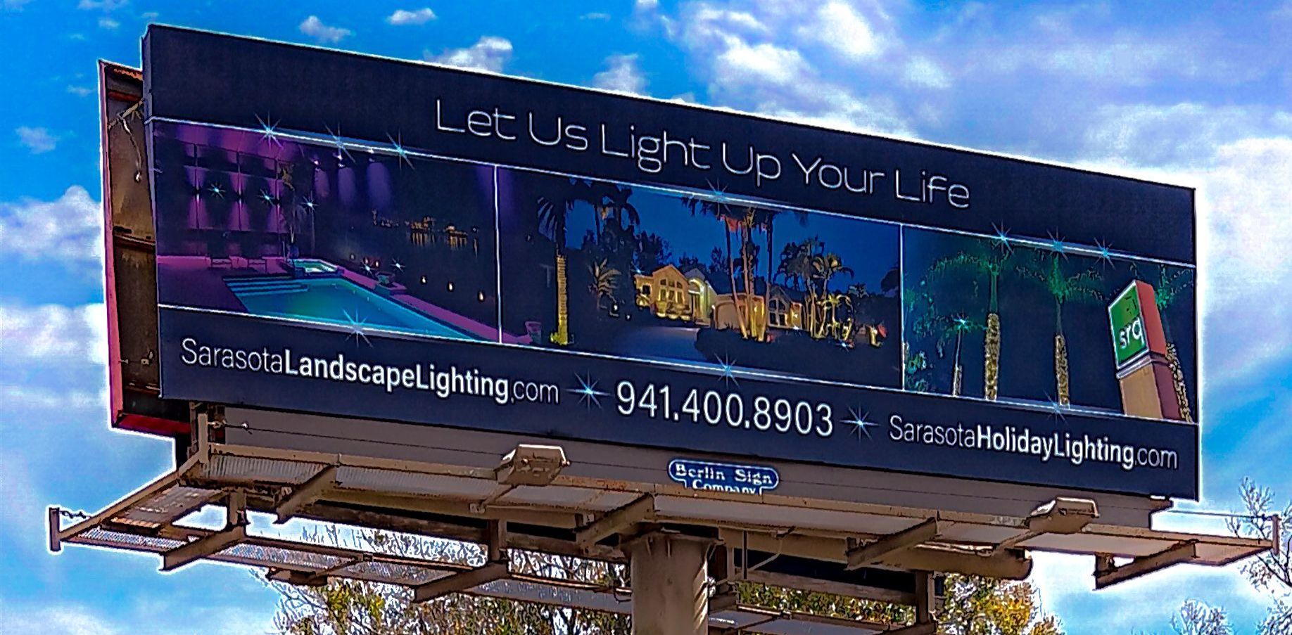 A large billboard that says let us light up your life