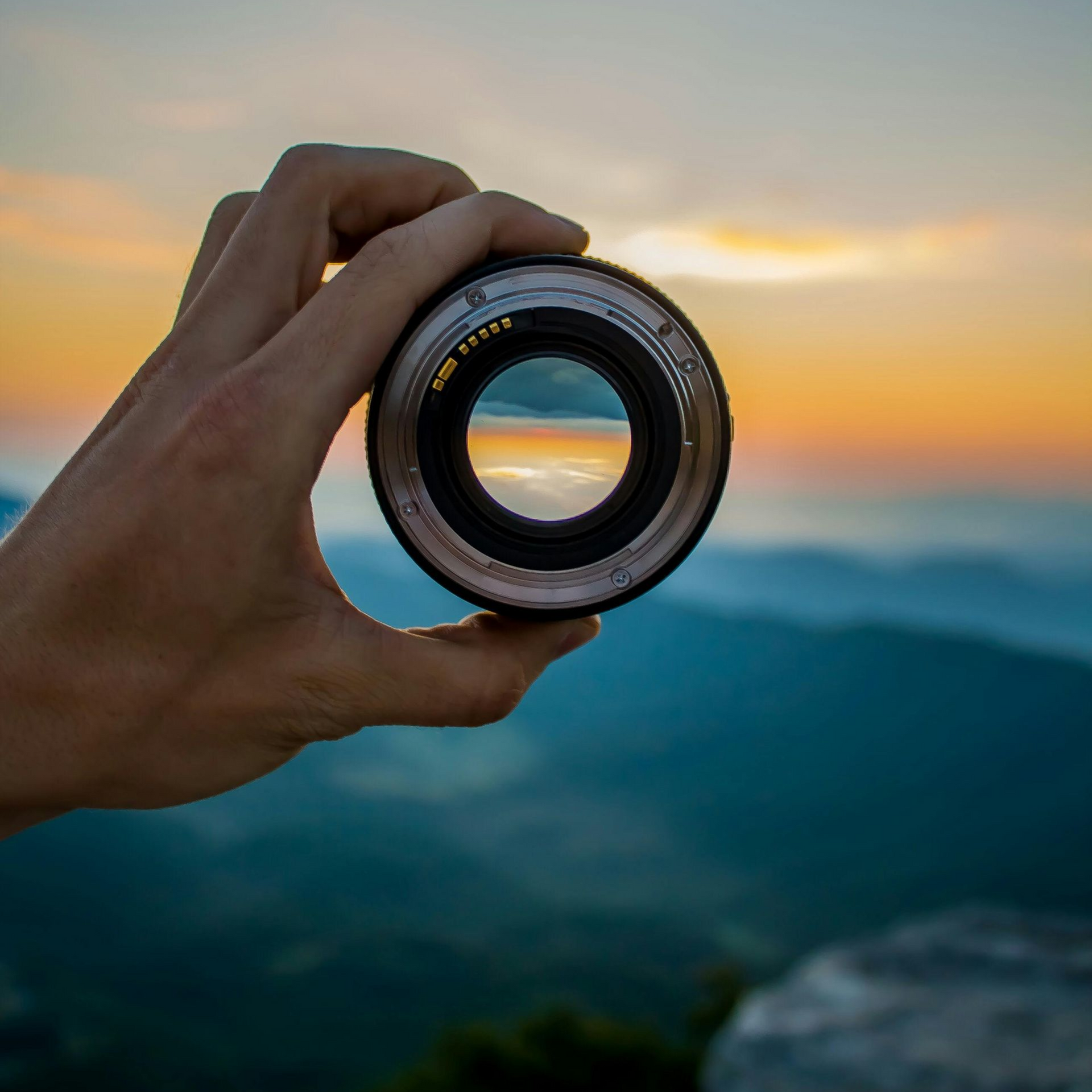 A person holding a lens overlooking the horizon
