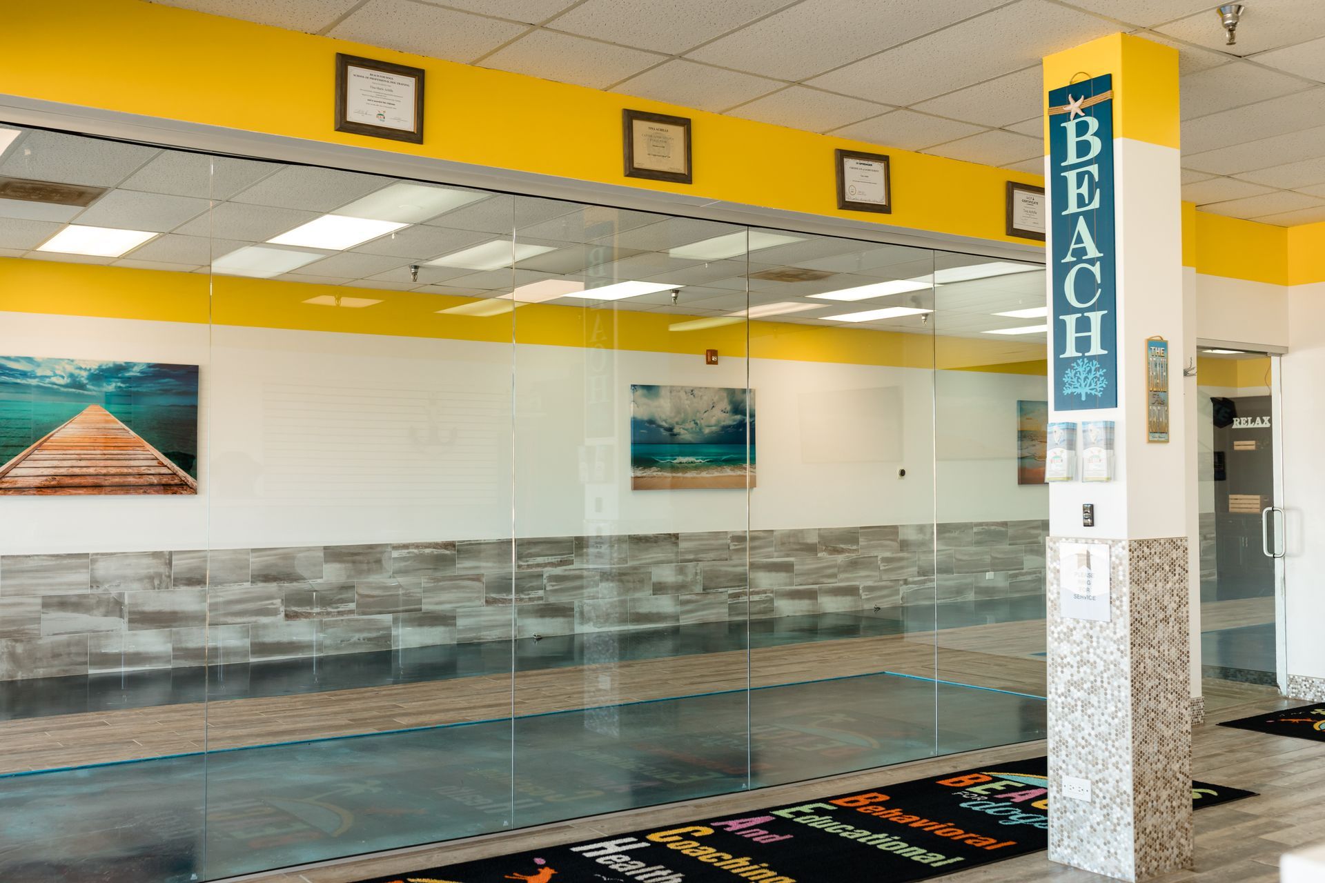 A large room with a swimming pool and a sign that says beach.