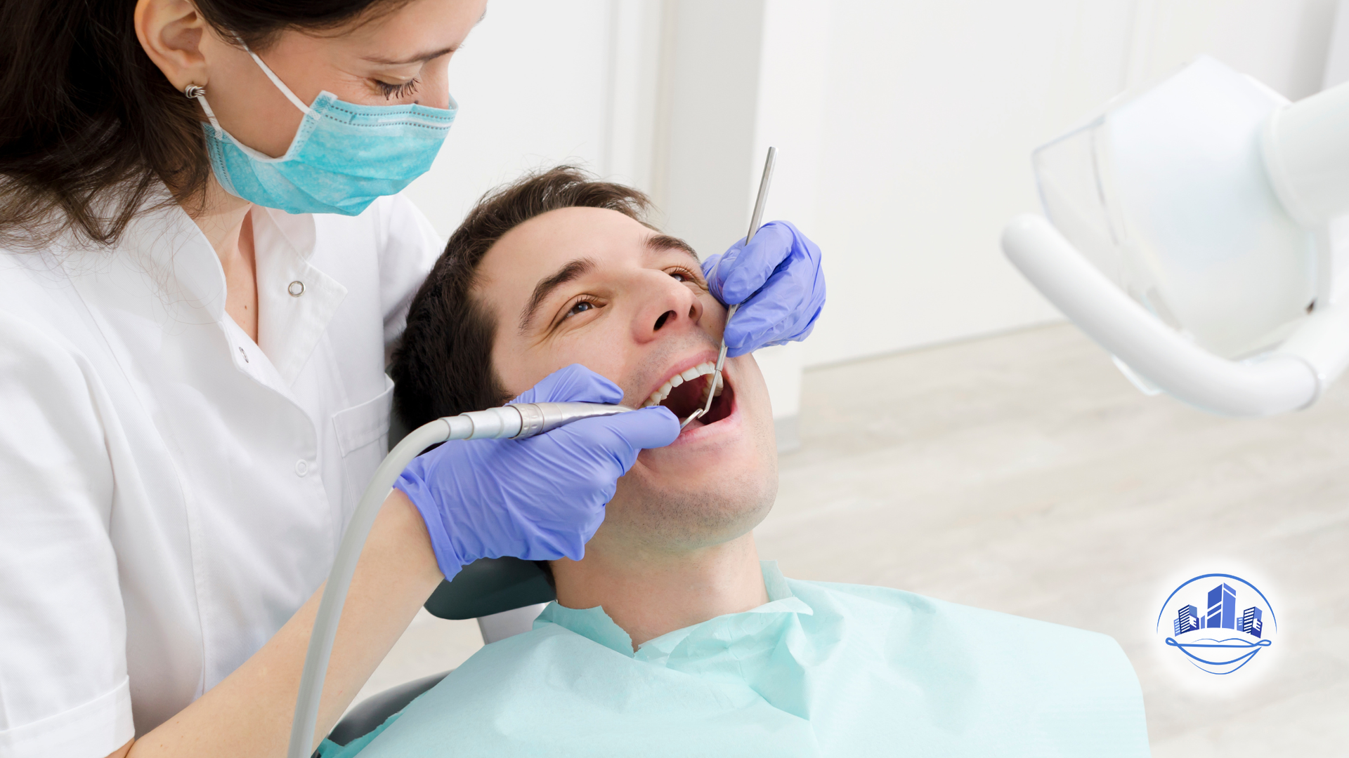 Dentist examining patient's teeth with tools in a dental office.