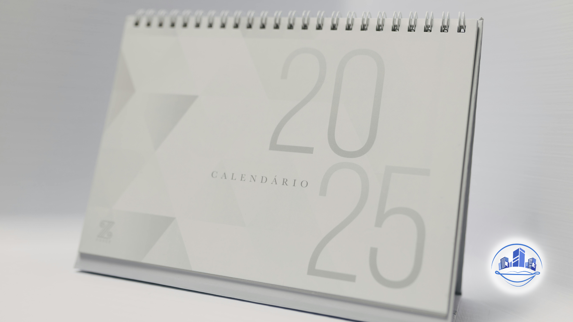 A 2025 calendar on a desk, silver and white with the word 