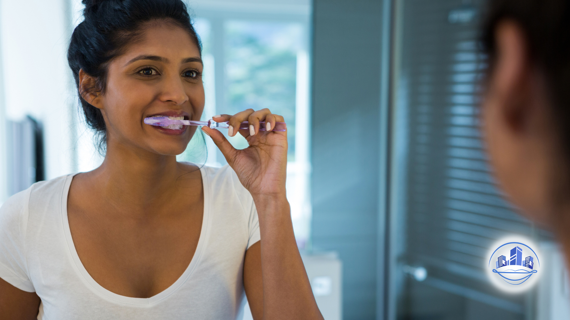 Woman brushing teeth with a green toothbrush, mouth open, white foam visible.