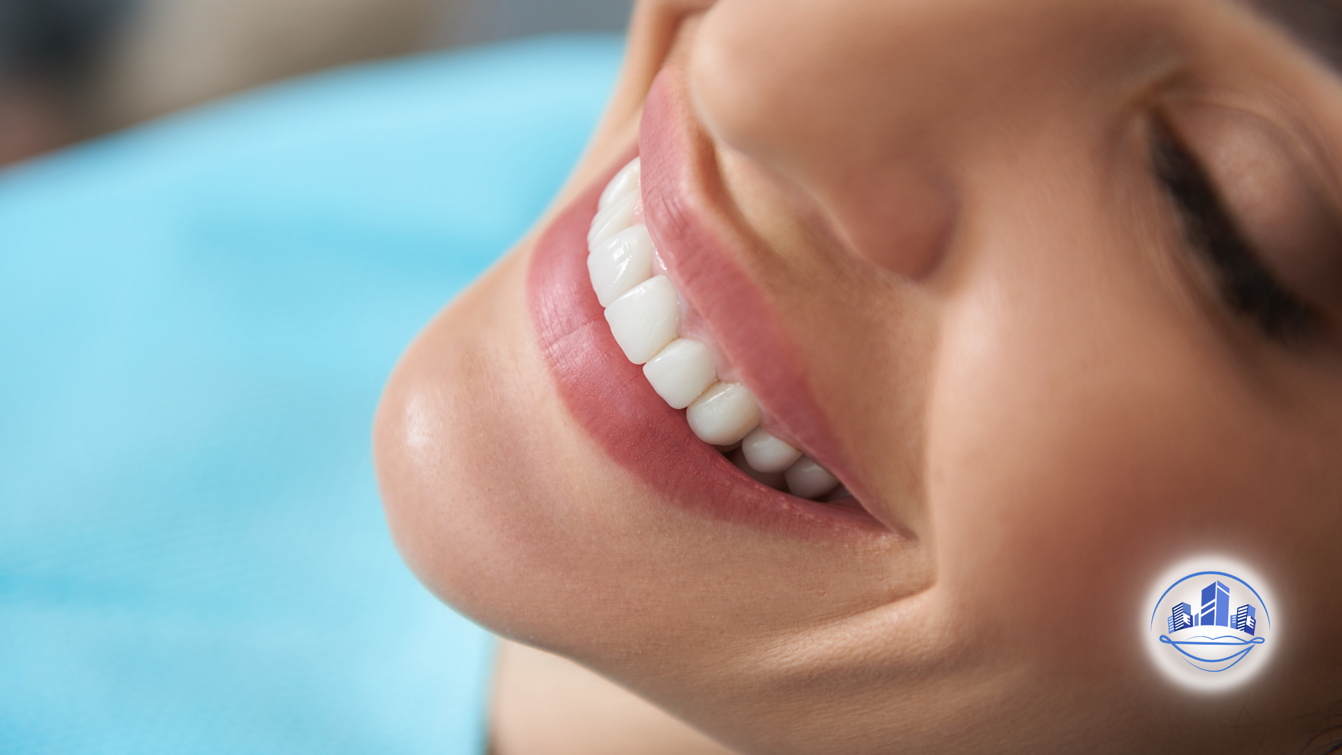 Woman smiling, showing perfect white teeth; close-up of mouth, face in dental chair.