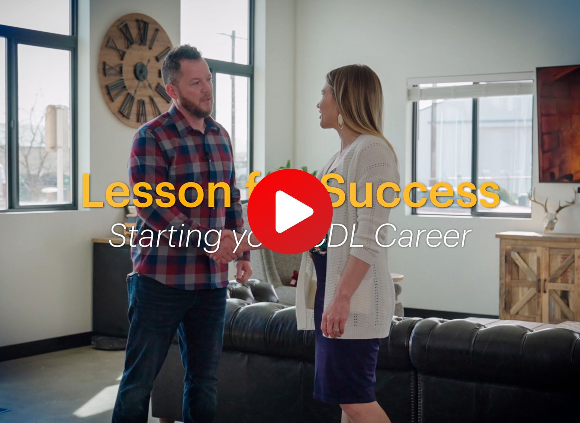 A man and a woman are standing in a living room talking to each other. The man is a CDL student and the women is a CDL admin