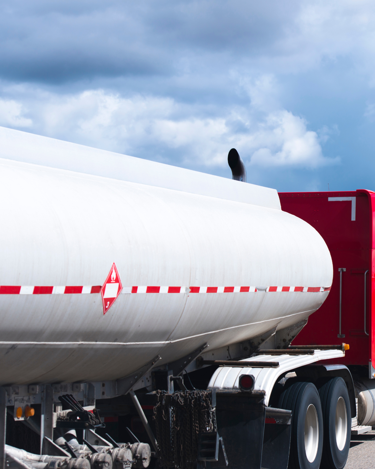 A red semi truck hauling hazardous materials waste