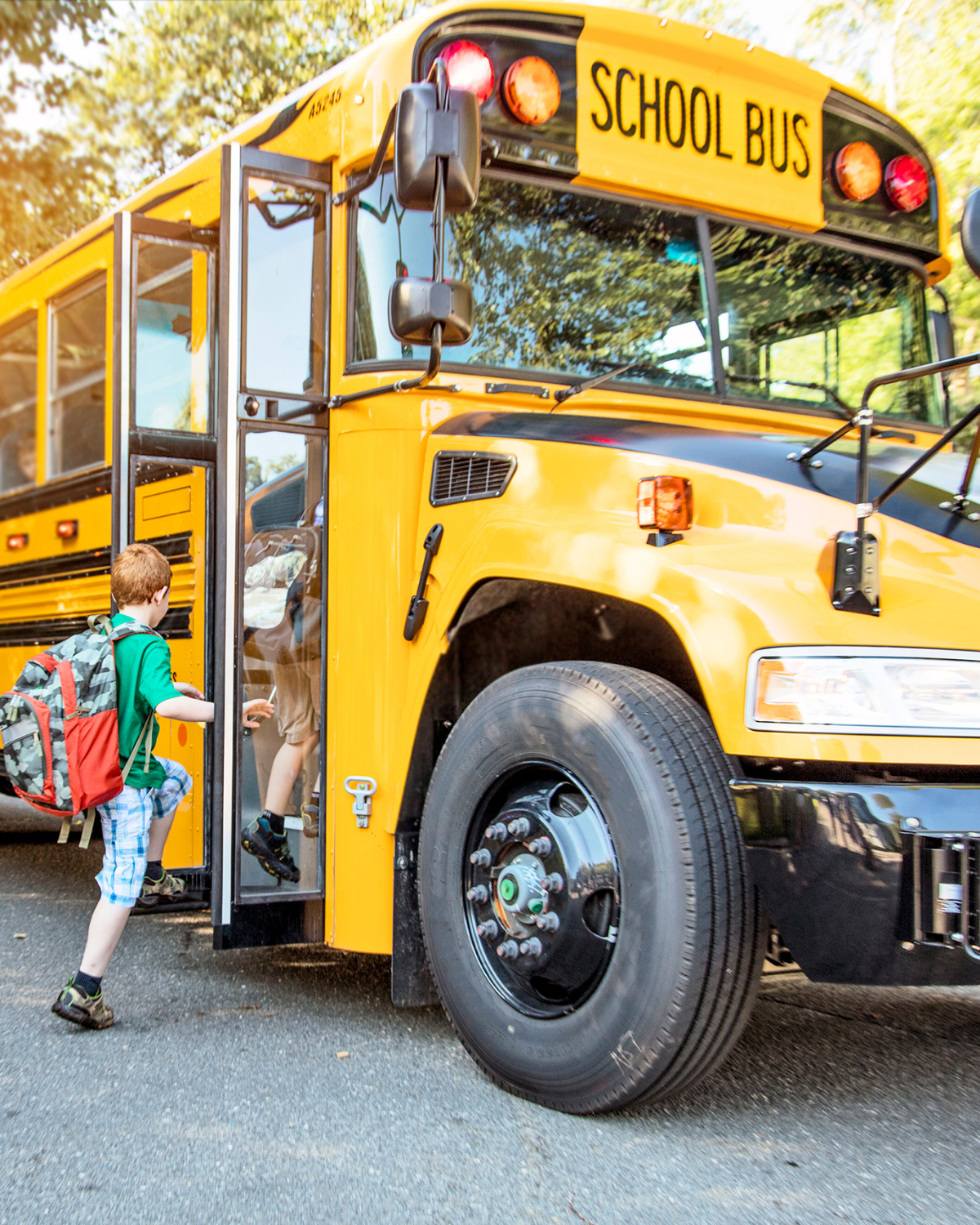 A school bus picking up children at a bus stop