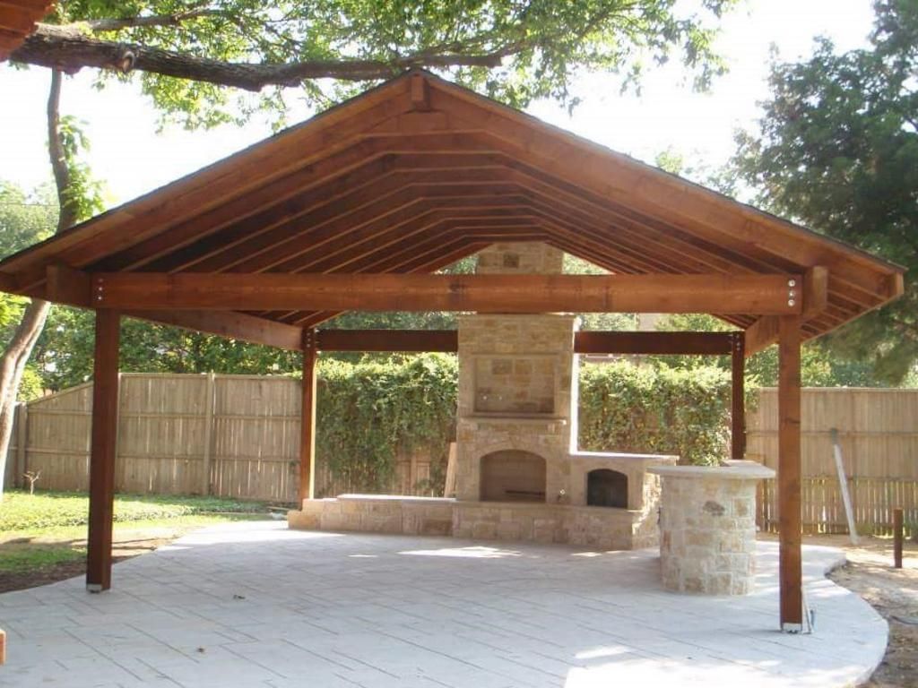 A wooden pavilion with a fireplace underneath it